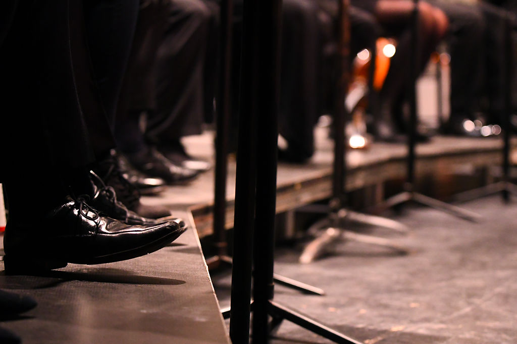 A member from University of Missouri Wind Ensemble taps his shoes